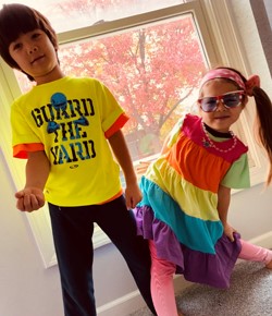 a boy and girl dressed in 80s clothes
