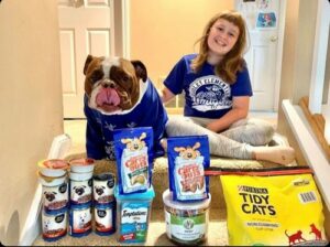 Ella with her donations and her dog Hamilton