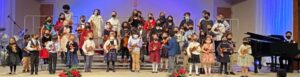 Students standing on stage during EIM violin concert