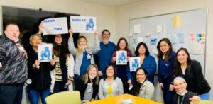 Photo of hospital staff thanking Dooley for collecting money