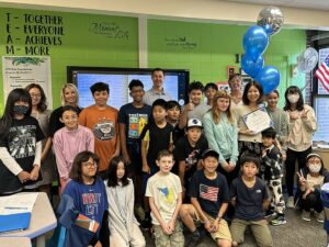 Mrs. Abe and District staff and students posing together