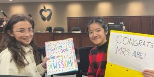 Abe celebration with two students holding signs